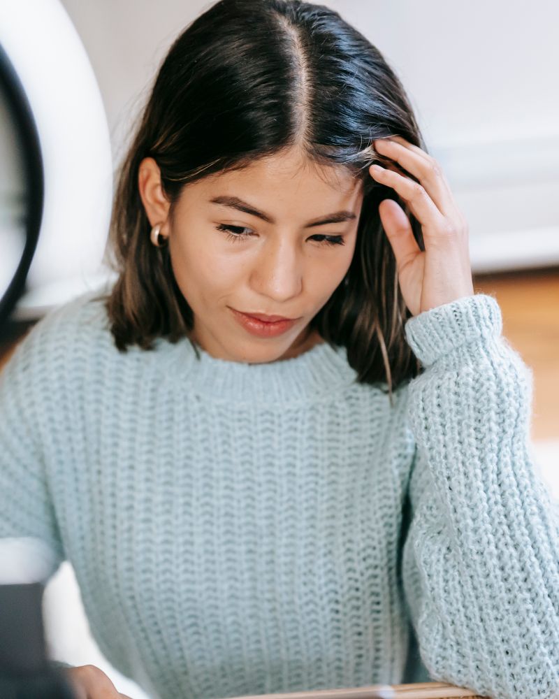A creator at her ring light between takes
